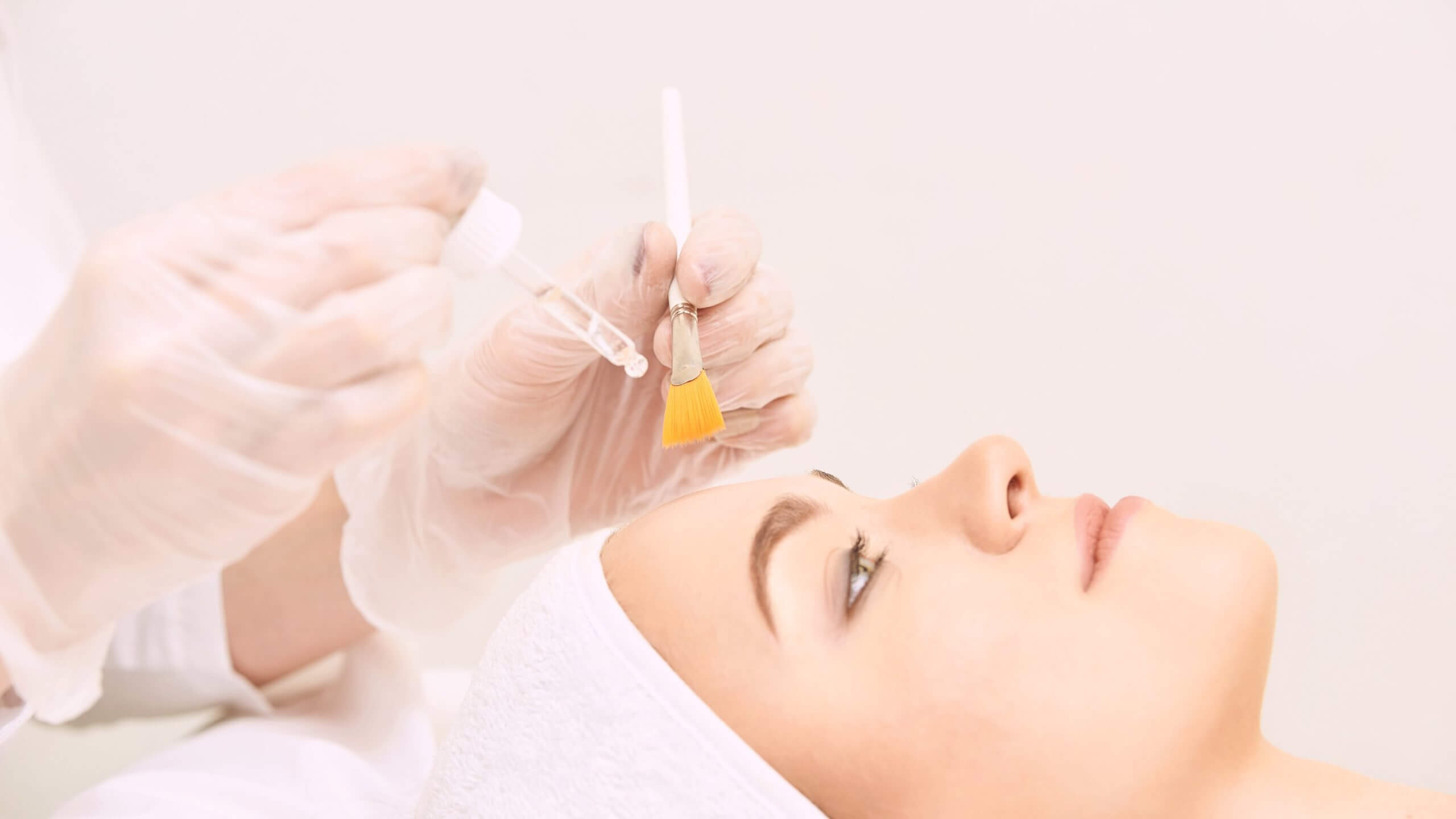 Keep your beauty! Beautiful woman getting skin cleaning and face Medical-Grade Chemical Peel treatment at beauty salon cosmetologist takes care of her face | Casa Glow Inc in East 22nd Street New York