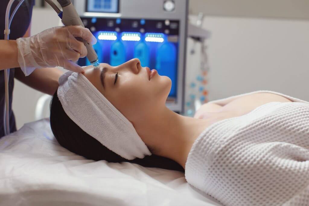 Adult woman during rf-lifting face skin tightening with her beautician at a beauty salon, close-up | Casa Glow Inc in East 22nd Street New York